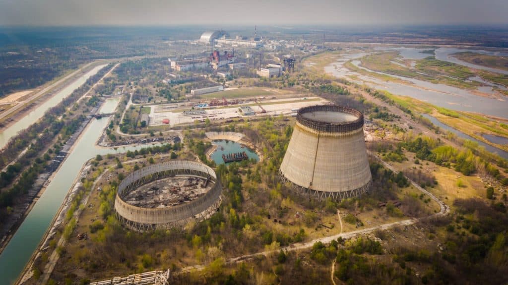 Aerial shot of Chernobyl nuclear reactors with straight canals around in spring