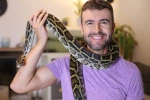 Man with beautiful pet snake