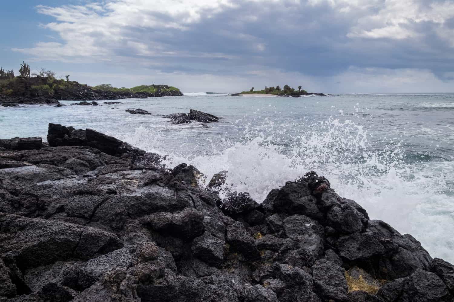 Very nice waves crushing over the rocks on the shore of the beach at Floreanda island, Galapagos, Ecuador
