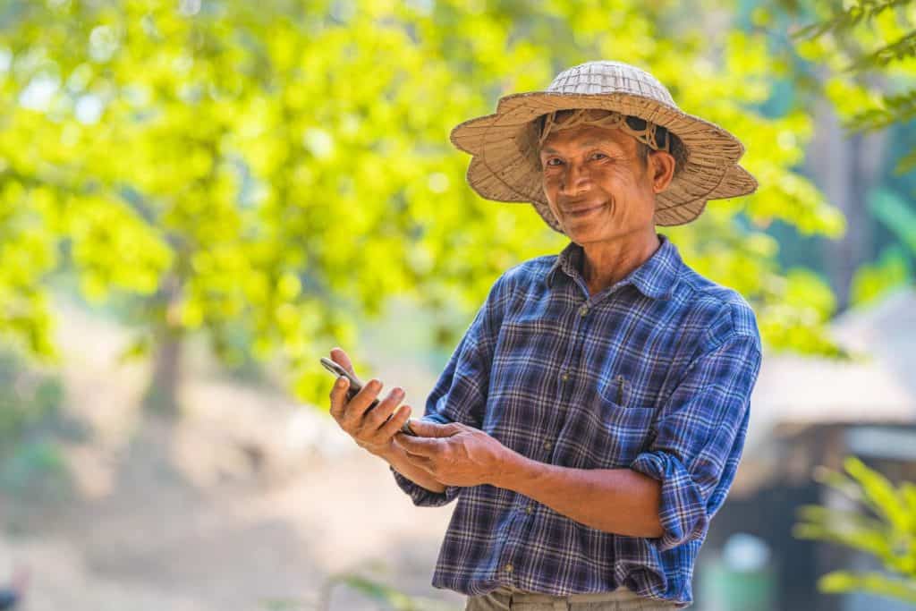 Asian man farmer with mobile phone business and technology concept,Asian man farmer on empty copy space
