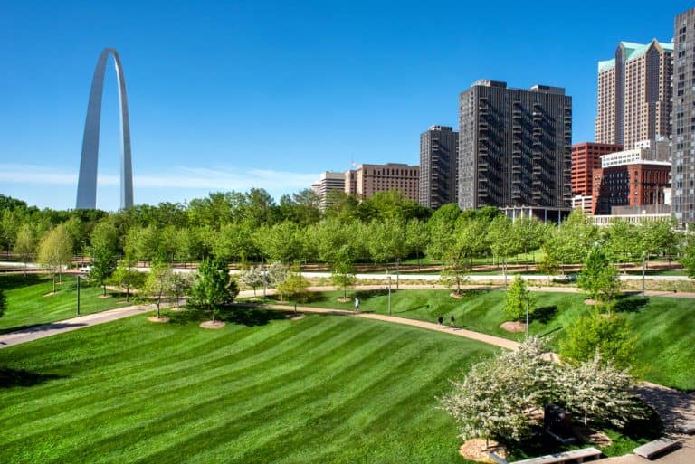 People walking on walking and biking trails at the Gateway Arch National Park in St. Louis, Missouri.