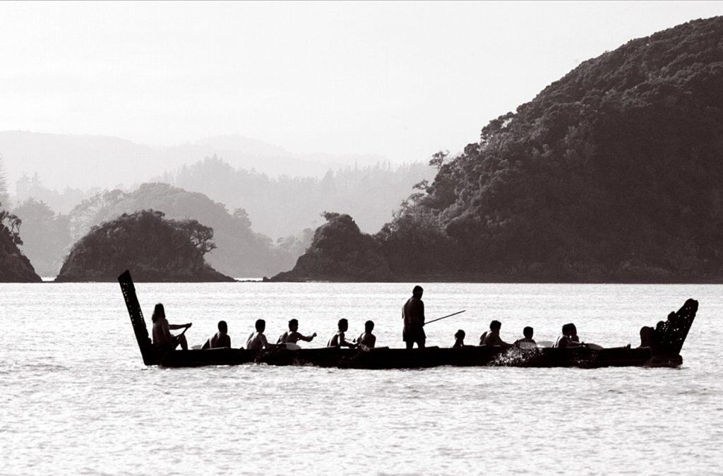 Silhouette of crew rowing a traditional Maori waka war canoe boat on 6 February during Waitangi Day, the national day of New Zealand, near Paihia in the Bay of islands, New Zealand.