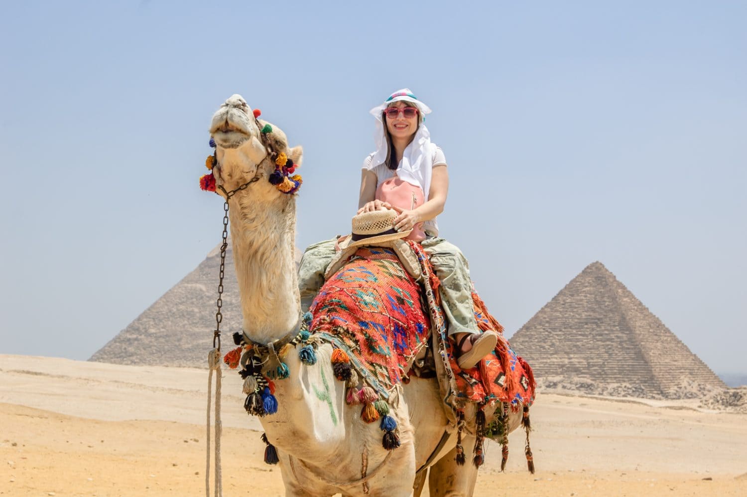 Woman riding a camel in the desert