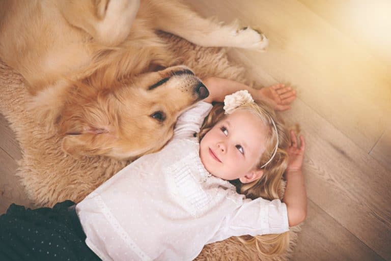 Were in this together, kid. An adorable little girl with her dog at home.