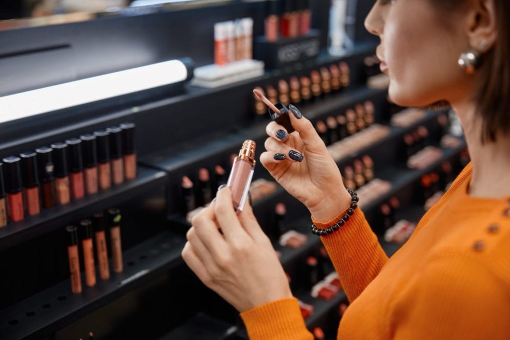 Young woman testing cosmetics in make-up store