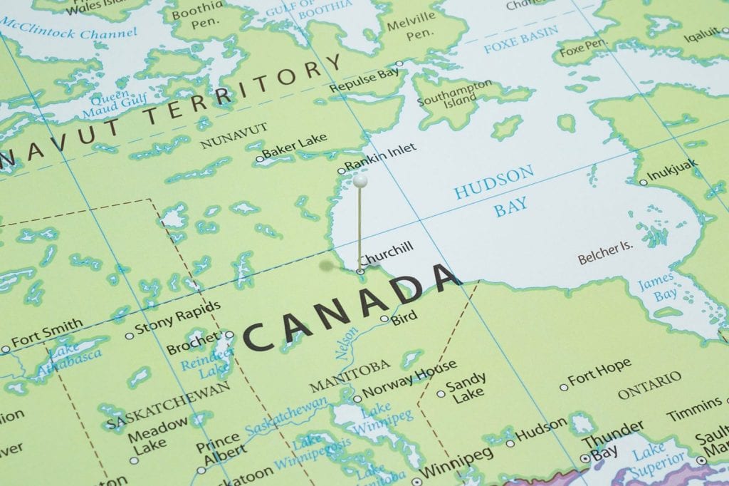 Close up to a Churchill city with a white pin needle into Canada country political map
