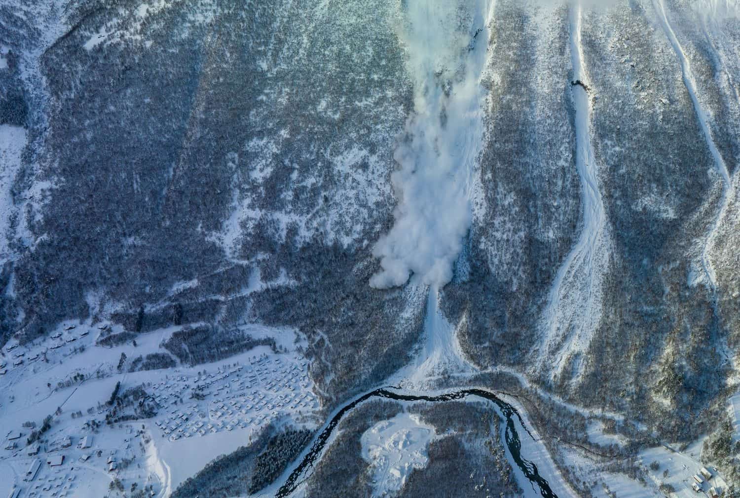 Avalanche in norwegian mountain close buildings 