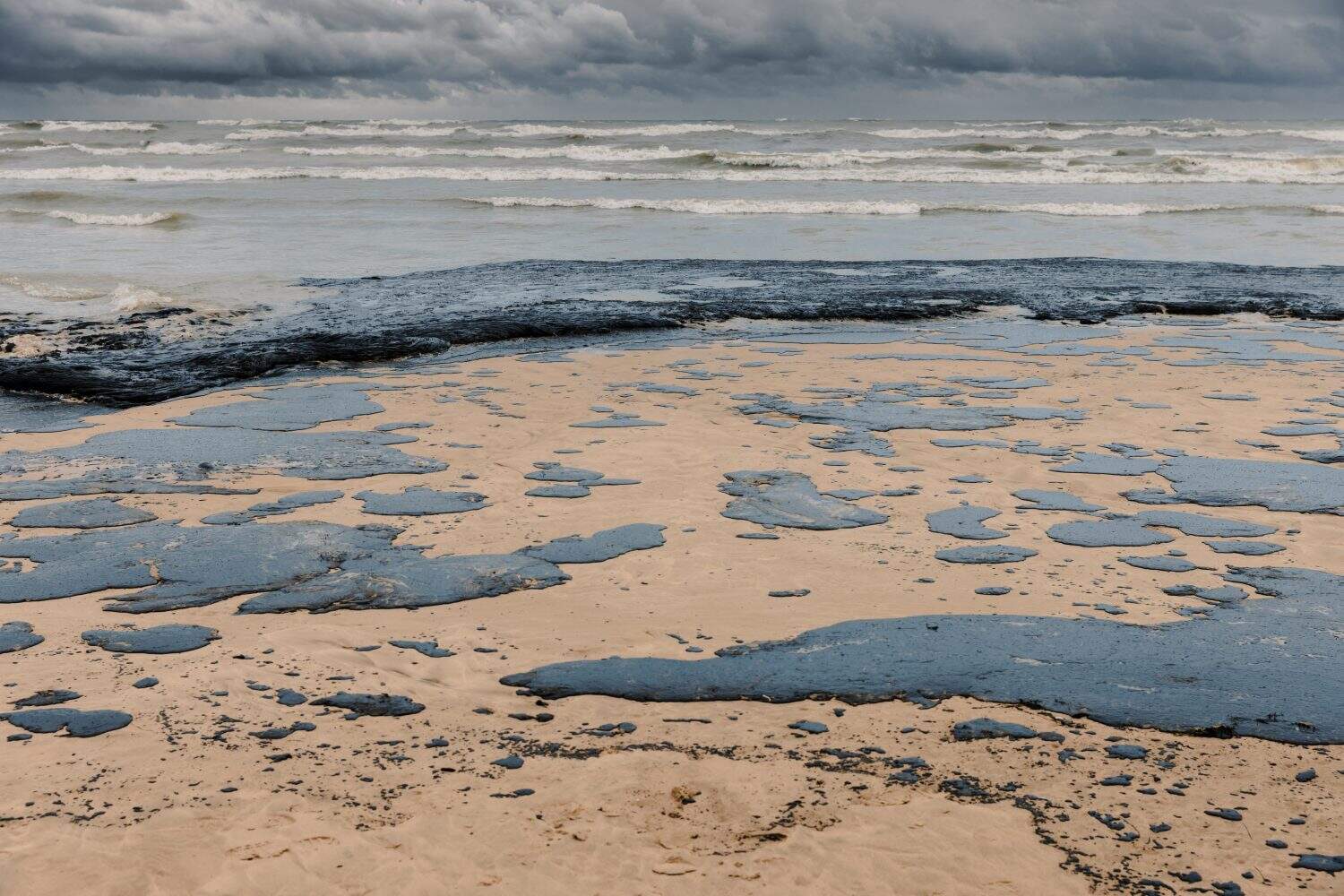 Oil in sea coastline after a tanker wreck. Fuel oil polluted beach