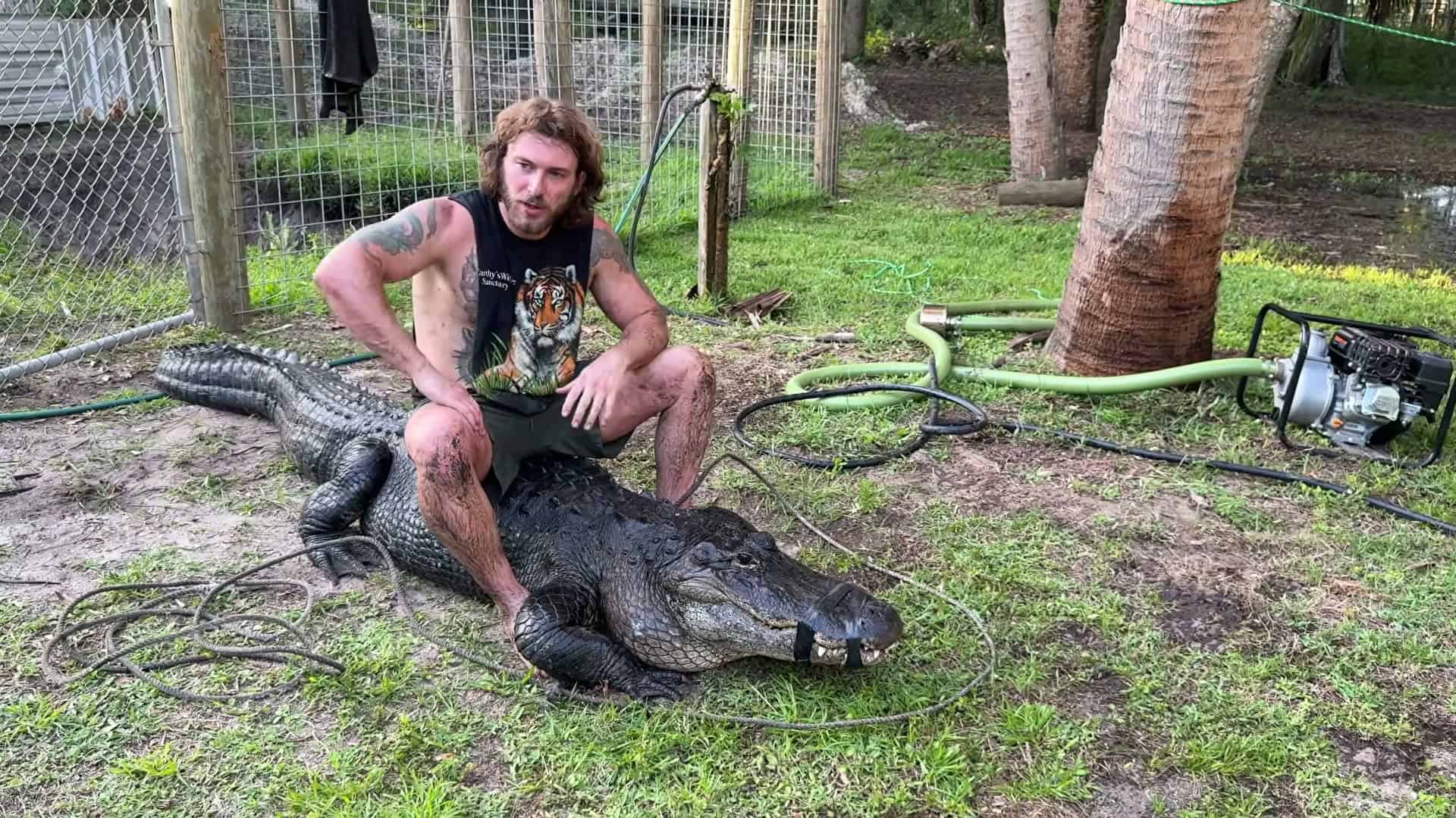 Clean hero shot &mdash; man posed on massive gator