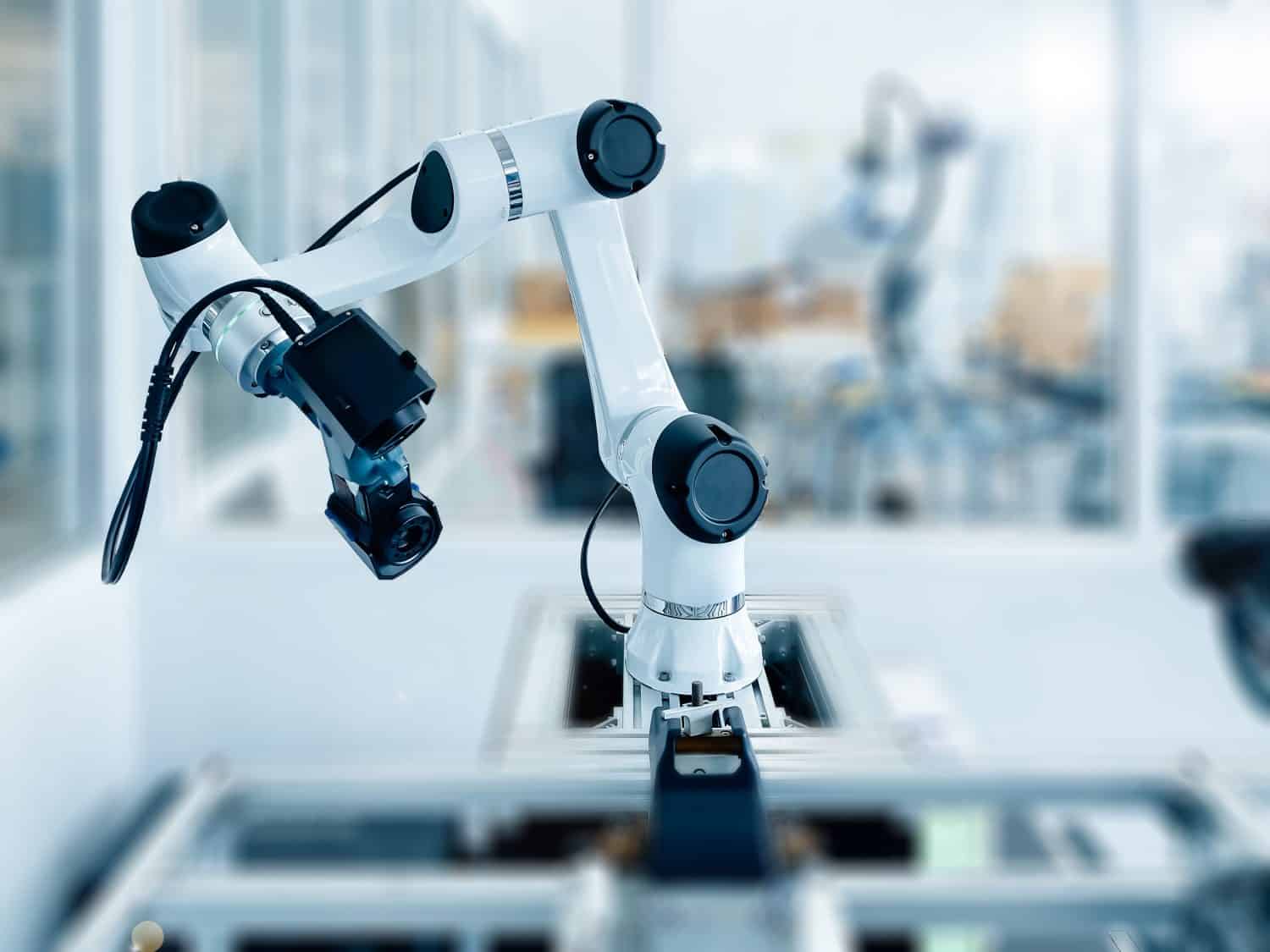 Robotic arm equipped with high-tech 3D scanner in an advanced manufacturing facility. Precision and automation in industrial technology.