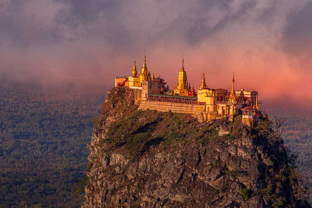 Mount Popa temple, region of new monkeys, shimmers at dusk